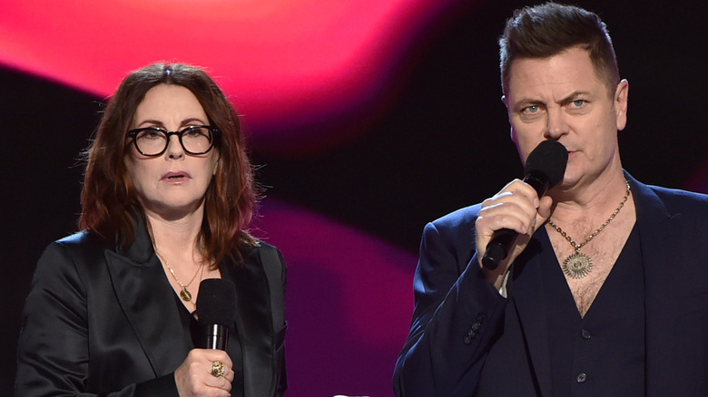 Megan Mullally black glasses Nick Offerman gold medallion 