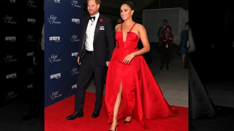 Prince Harry and Meghan Markle wearing red dress