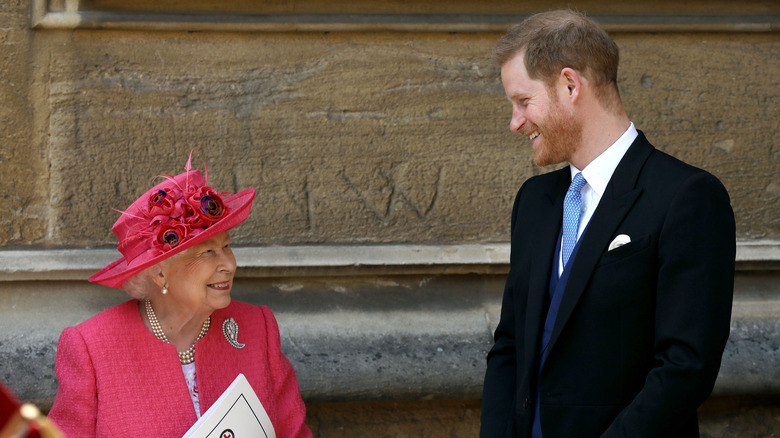 The queen and Prince Harry smiling