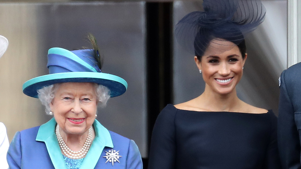 Queen Elizabeth II and Meghan Markle pose side by side at an event