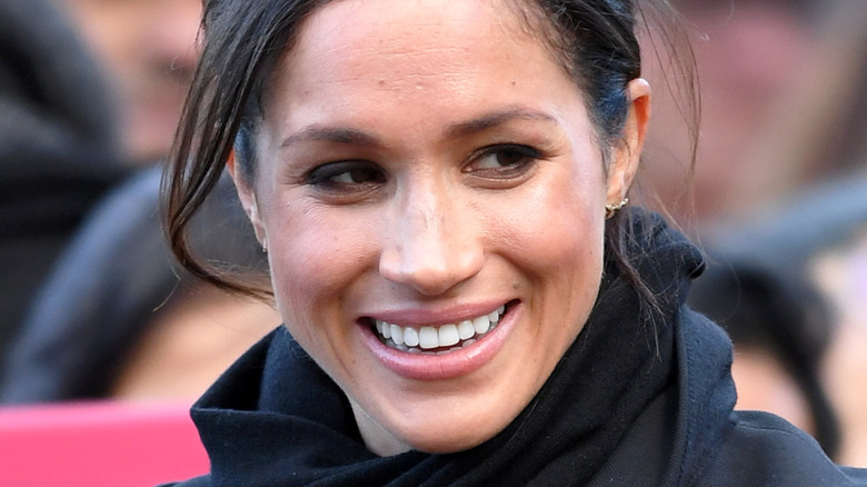 Close-up of Meghan Markle smiling with tousled hair