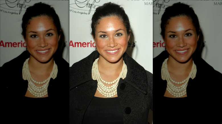 Meghan Markle wearing layered pearl necklace and blush