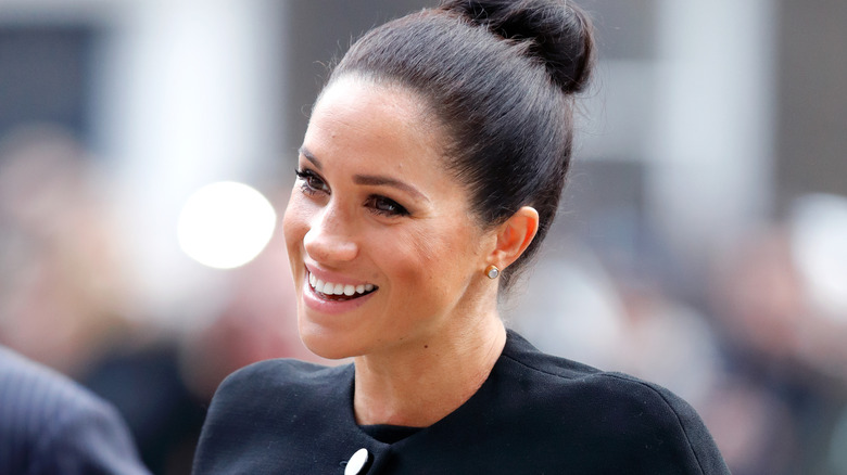 Meghan Markle with her hair pulled back into a bun