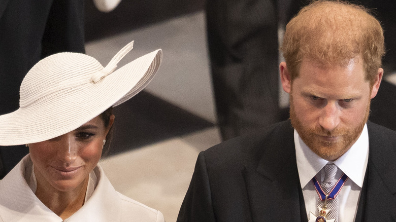 Meghan Markle and Prince Harry bow heads at church