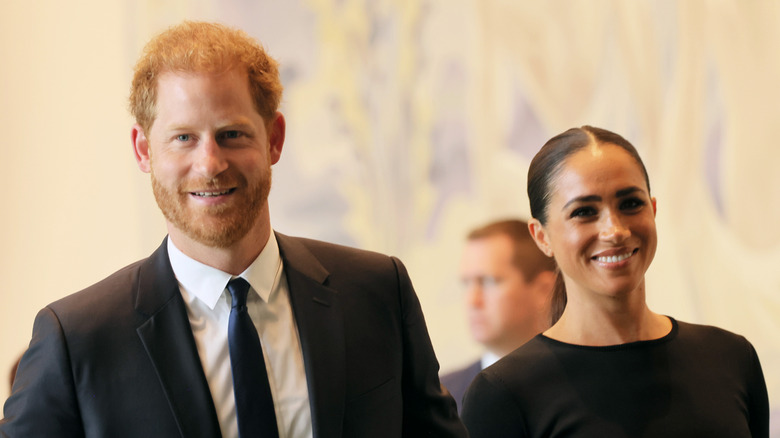 Meghan and Harry dressed up smiling 