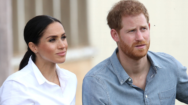 Meghan Markle and Prince Harry looking on