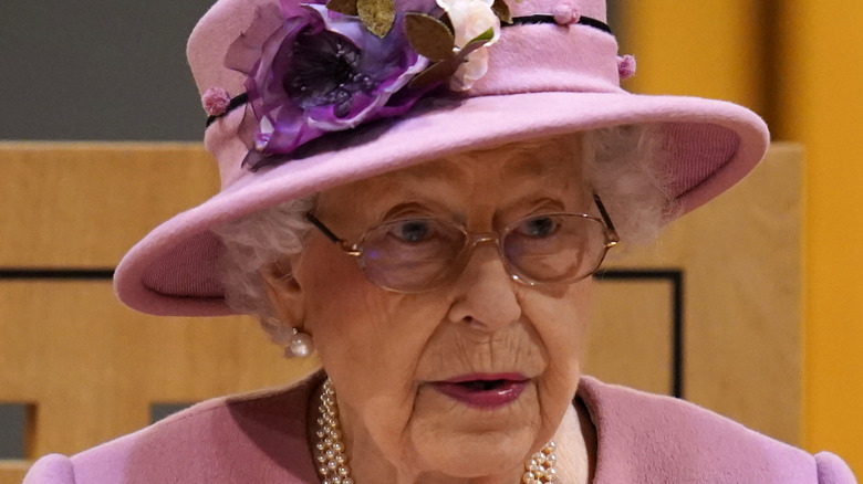 Queen Elizabeth glasses pink hat flowers