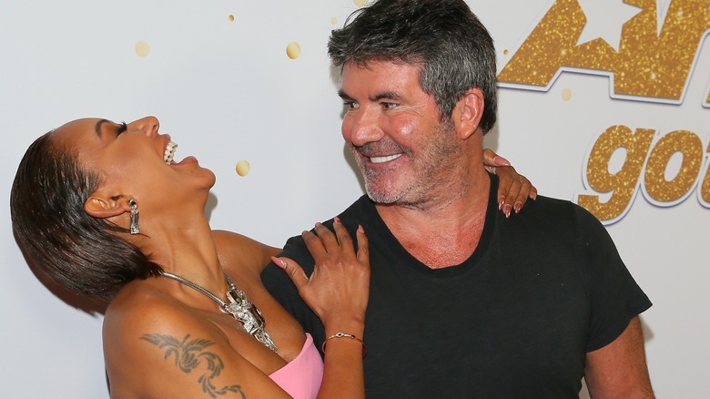 Mel B and Simon Cowell laughing