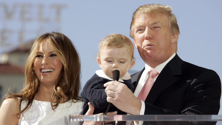 Melania Trump smiling, Donald Trump holding Barron Trump