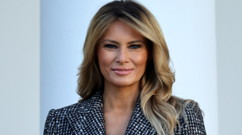 Melania Trump wearing dark makeup and smiling