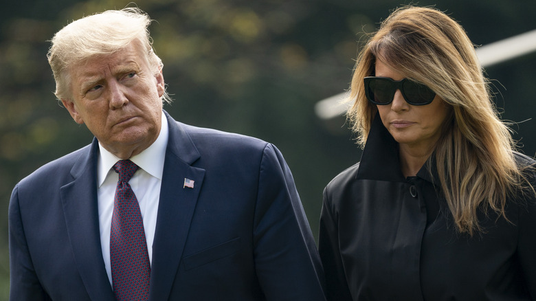 Donald Trump and Melania Trump walking outdoors