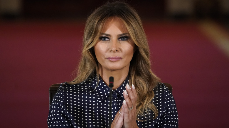 Melania Trump claps in polka-dot dress