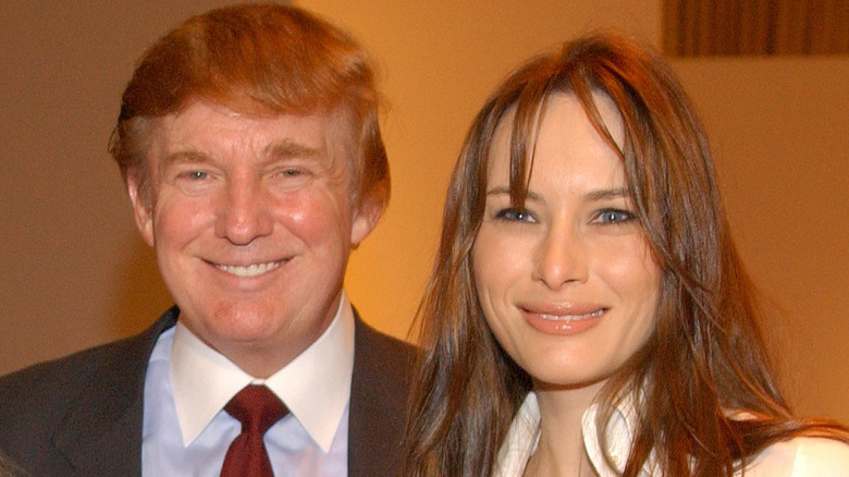 Donald Trump and Melania Trump smiling in 2002