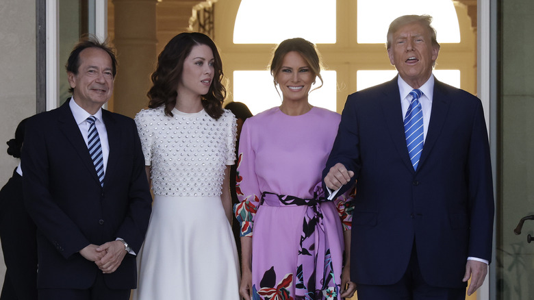 Melania Trump smiles next to Donald