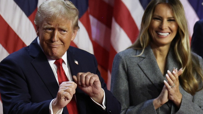 Donald Trump dances onstage during election night 2024 as Melania Trump smiles and claps