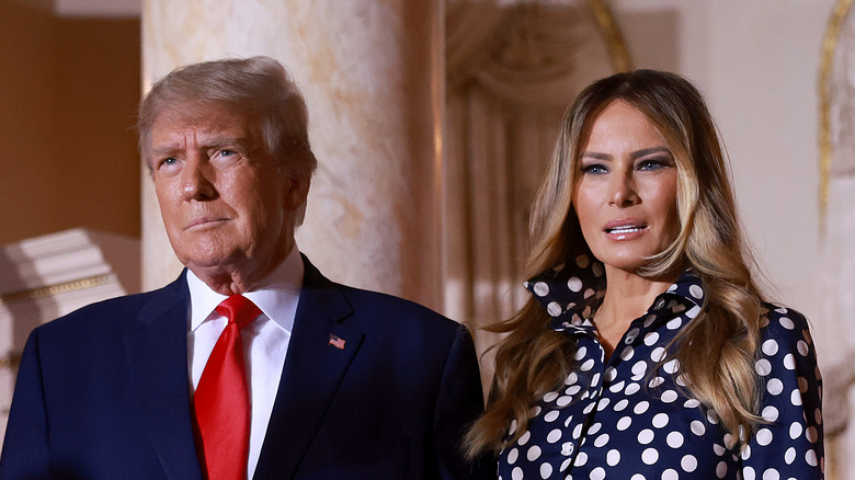 Donald Trump and Melania Trump standing