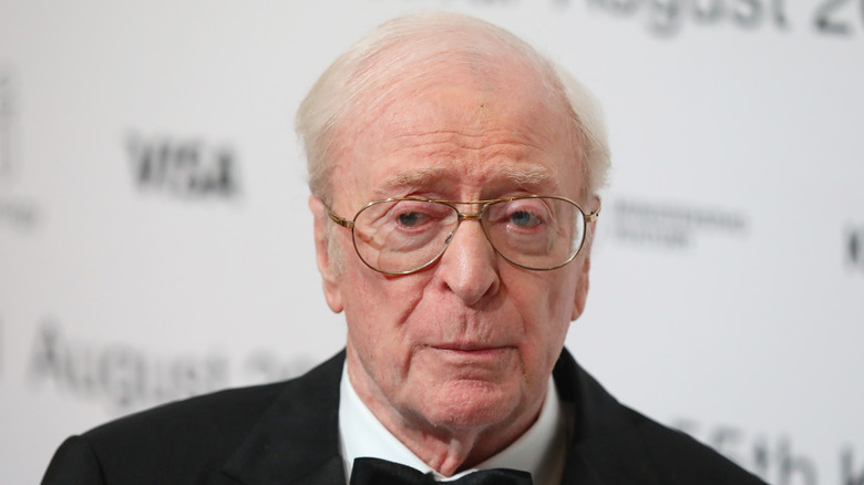 Michael Caine wearing glasses with serious expression