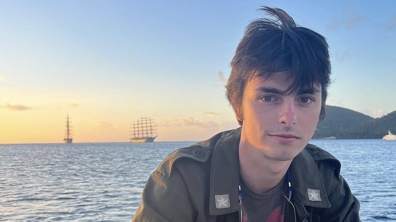 Dylan Douglas poses by the water in Dominica