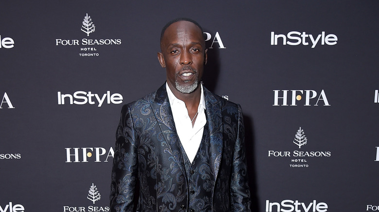 Michael K. Williams posing at step and repeat