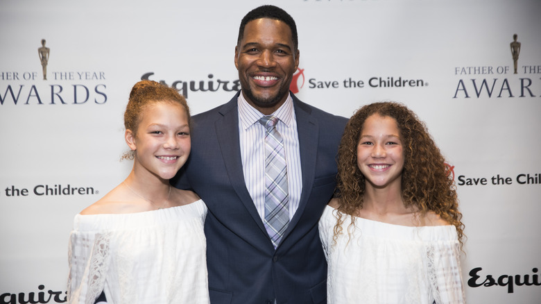 Michael Strahan and daughters posing