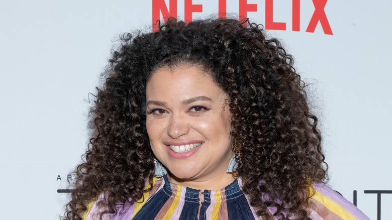 Michelle Buteau smiling for press