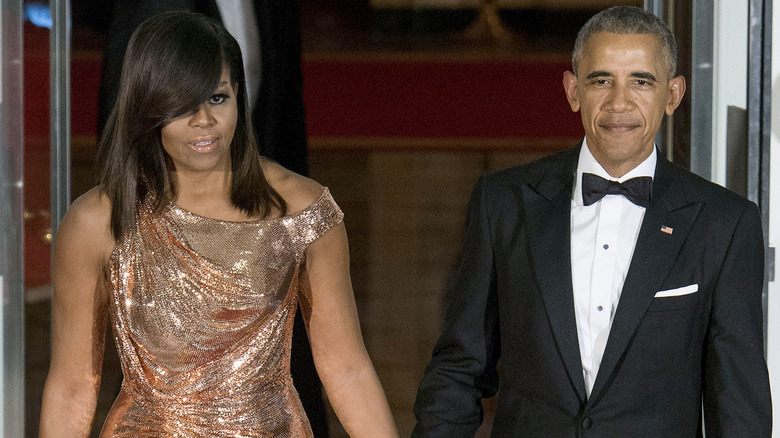 Michelle Barack Obama holding hands