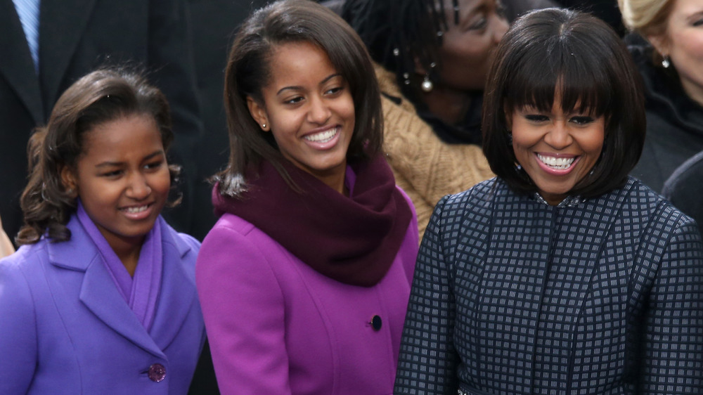 Michelle Obama and daughters smiling