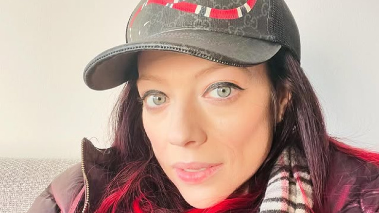 Michelle Trachtenberg wearing a gray baseball cap