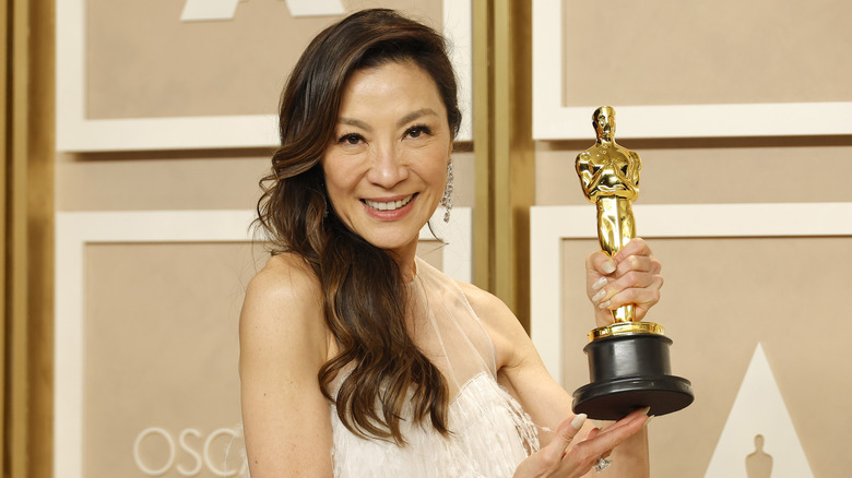 Michelle Yeoh poses with her Oscar award