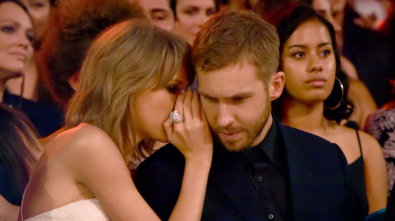 Taylor Swift whispering to Calvin Harris