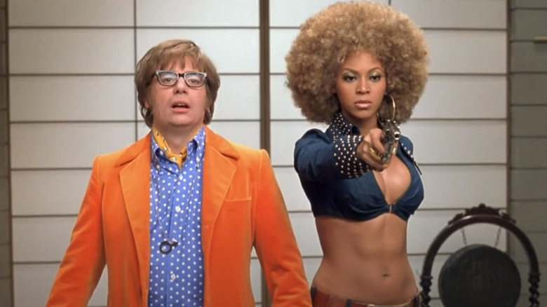 Beyoncé holding gun beside Mike Myers