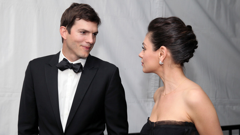 Ashton Kutcher and Mila Kunis looking at each other