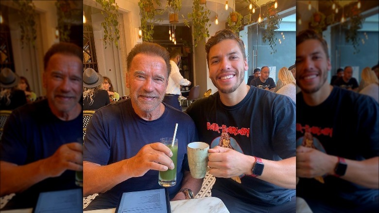 Joseph Baena and Arnold Schwarzenegger pose holding drinks