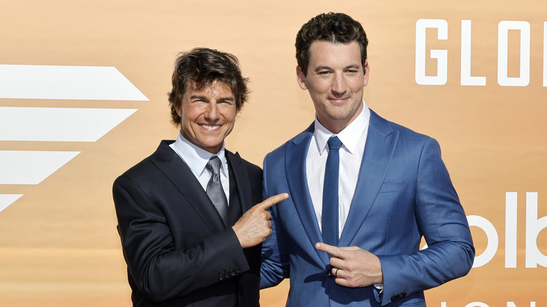 Tom Cruise and Miles Teller smiling