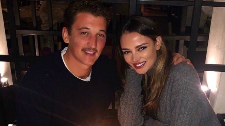 Miles Teller and Keleigh Sperry Teller smile at a dinner table