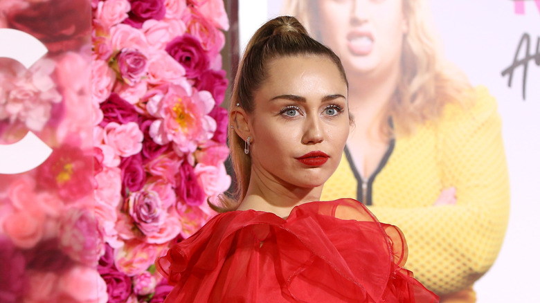 Miley Cyrus posing at a movie premiere 