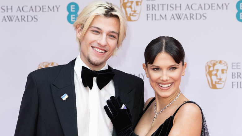 Jake Bongiovi and Millie Bobby Brown smiling on the red carpet