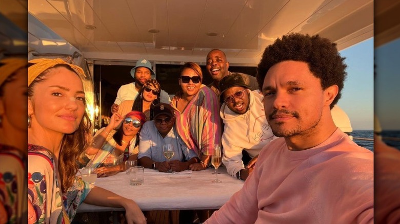 Minka Kellly and Trevor Noah aboard a yacht