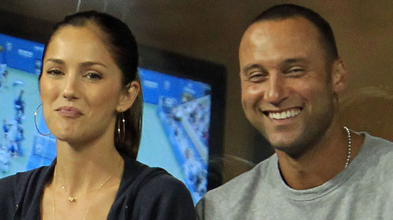 Minka Kelly and Derek Jeter smiling at a ballgame