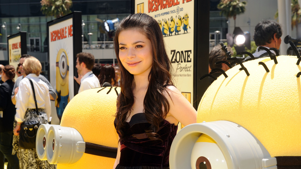 Miranda Cosgrove with minions on the red carpet at the Despicable Me premiere