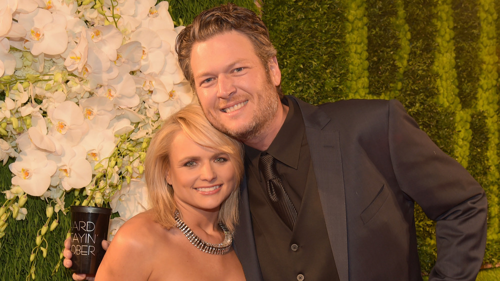 Miranda Lambert and Blake Shelton smiling at an event