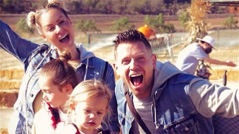 Maryse and Mike The Miz Mizanin posing with kids