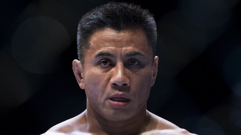 Cung Le with a serious expression during a fight