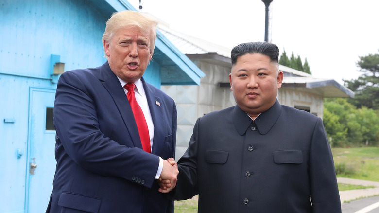 Donald Trump and Jim Jong-Un shake hands