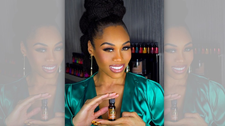 Monique Samuels holding essential oil