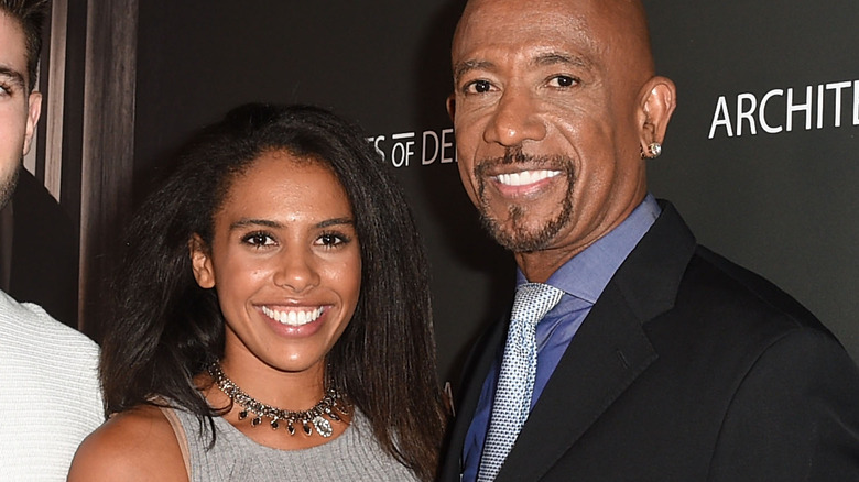 Montel Williams smiling with daughter and wife