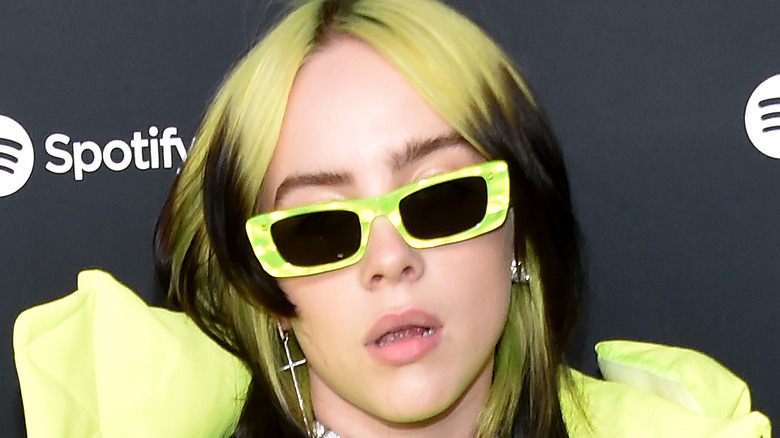Billie Eilish with yellow sunglasses on