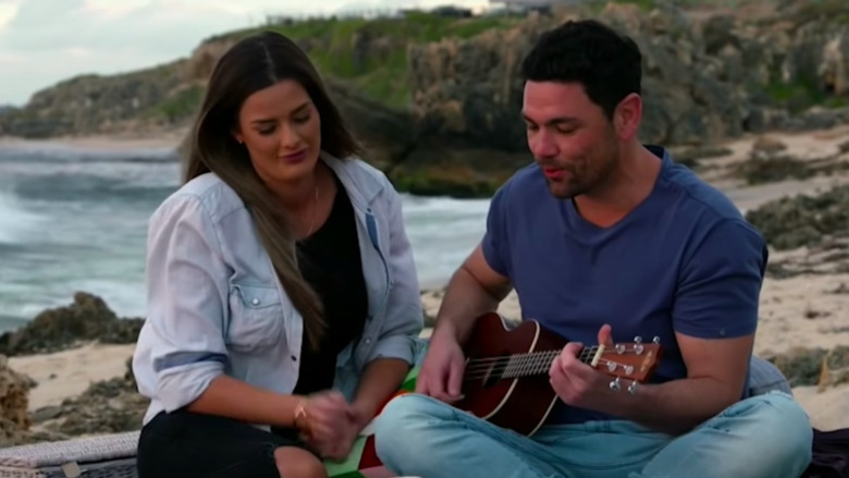 Cheryl Maitland and Andrew Jones sitting on beach together