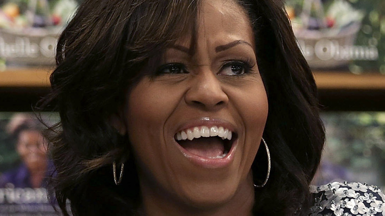 Michelle Obama silver hoop earrings laughing