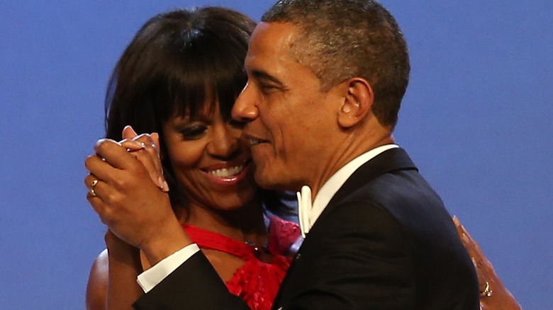 Barack Michelle Obama holding hands dancing